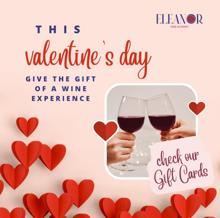 A romantic couple toasting with glasses of red wine, celebrating Valentine’s Day in a cozy, candlelit setting. Eleanor Wine Academy gift cards offer the perfect wine experience in Amsterdam, Utrecht, and The Hague