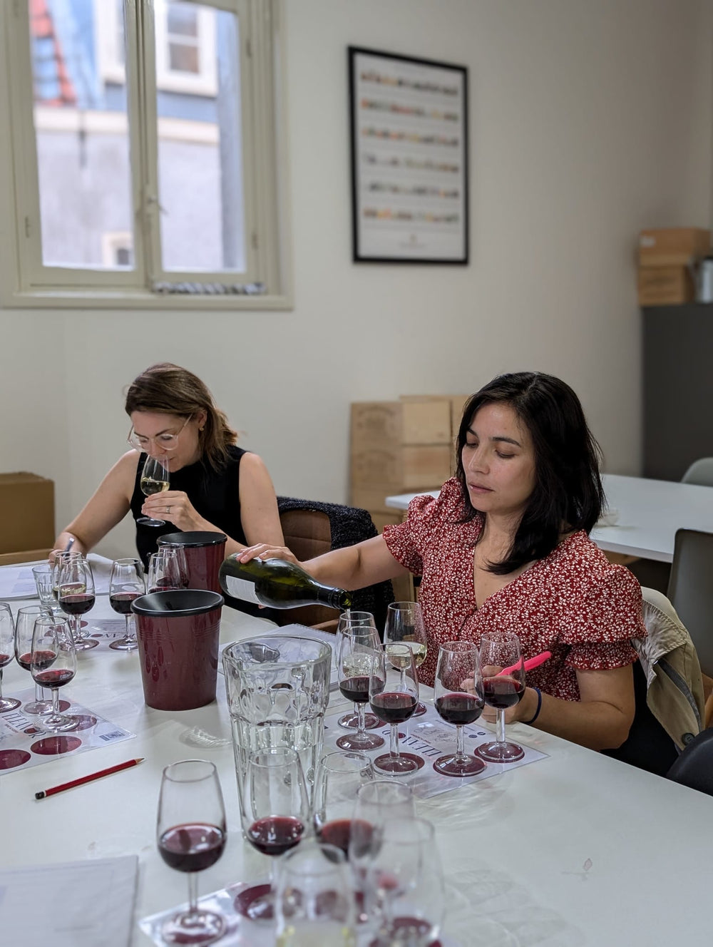 Student pouring wine during a guided WSET tasting in Amsterdam